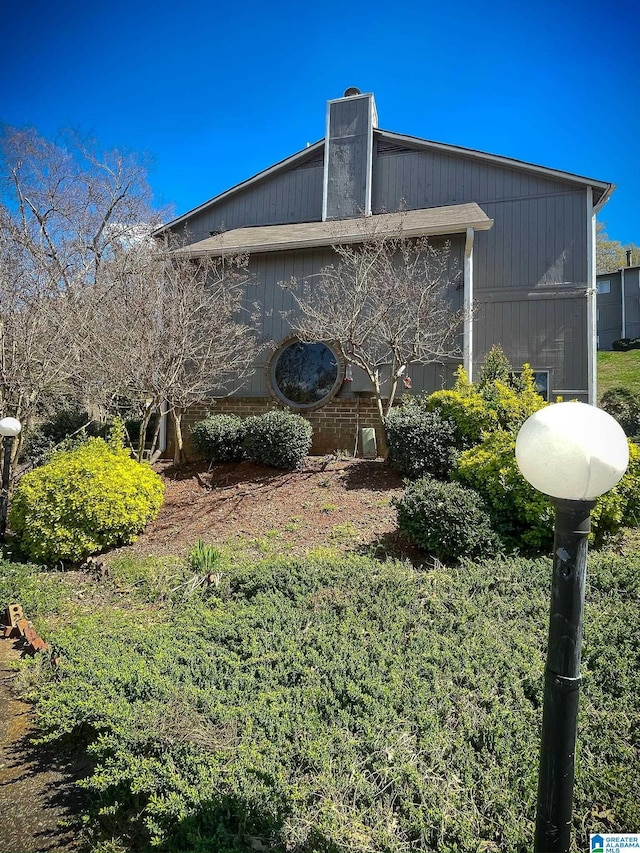 view of property exterior featuring a chimney