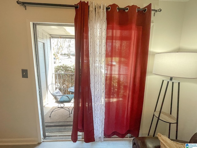 doorway to outside featuring baseboards