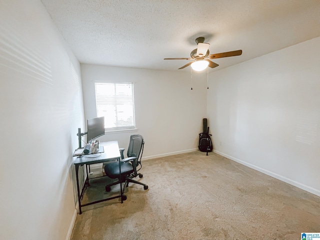 carpeted office with baseboards, a textured ceiling, and a ceiling fan