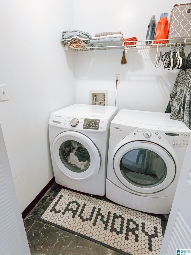 laundry area featuring baseboards, washer and dryer, and laundry area