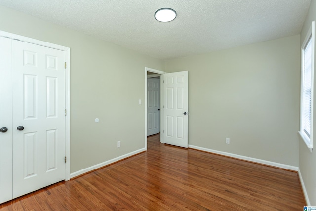 5400 Etta Dr, Mount Olive, AL 35117 - unfurnished bedroom with a textured ceiling, baseboards, and wood finished floors