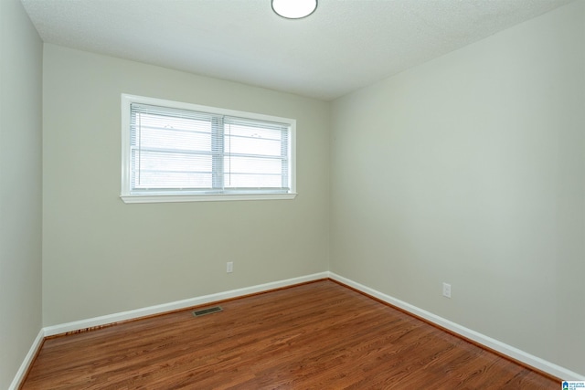 5400 Etta Dr, Mount Olive, AL 35117 - unfurnished room with baseboards, visible vents, and wood finished floors