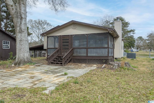 5400 Etta Dr, Mount Olive, AL 35117 - back of house featuring a sunroom, a chimney, and a yard
