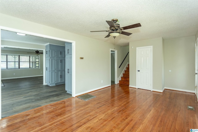 5400 Etta Dr, Mount Olive, AL 35117 - unfurnished room featuring baseboards, wood finished floors, stairway, and a ceiling fan