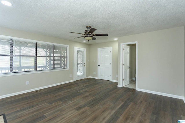 5400 Etta Dr, Mount Olive, AL 35117 - unfurnished living room featuring a textured ceiling, visible vents, baseboards, ceiling fan, and wood finished floors
