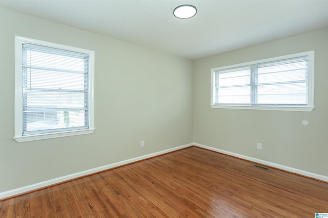 5400 Etta Dr, Mount Olive, AL 35117 - empty room featuring baseboards, visible vents, and wood finished floors