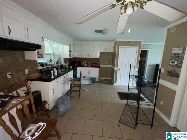 11 Coosa St, Childersburg, AL 35044 - kitchen with backsplash, a ceiling fan, dark countertops, white cabinets, and ornamental molding
