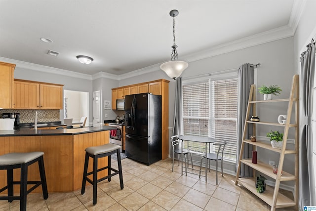 kitchen featuring tasteful backsplash, a peninsula, dark countertops, visible vents, and black appliances