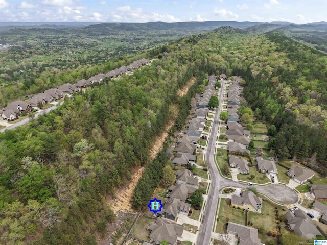 aerial view with a residential view, a view of trees, and a mountain view
