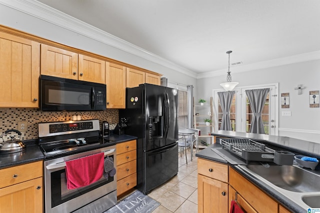 kitchen featuring dark countertops, black appliances, light tile patterned flooring, and a healthy amount of sunlight