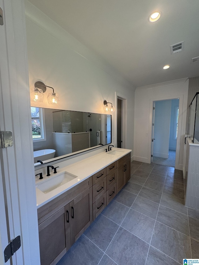 104 Linden Ln, Birmingham, AL 35242 - bathroom featuring a soaking tub, double vanity, a shower with door, recessed lighting, and tile patterned flooring