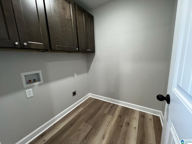 laundry area with hookup for a washing machine, baseboards, dark wood-style floors, cabinet space, and electric dryer hookup