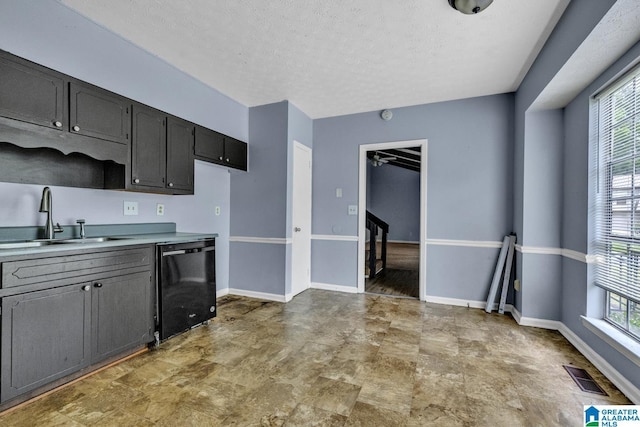 2610 Gaylon St, Birmingham, AL 35235 - kitchen with black dishwasher, a sink, light countertops, a textured ceiling, and baseboards