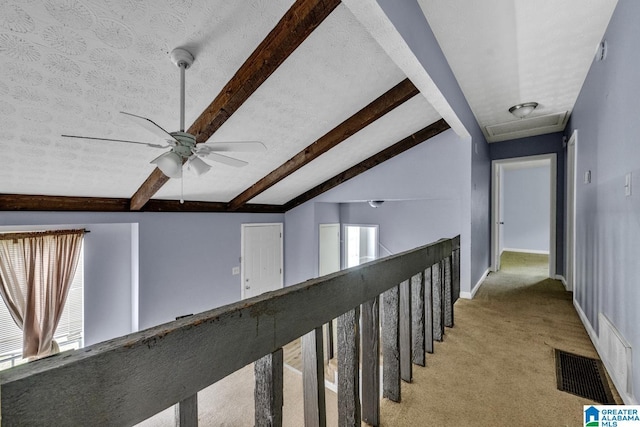 2610 Gaylon St, Birmingham, AL 35235 - hallway with beamed ceiling, light colored carpet, attic access, and baseboards