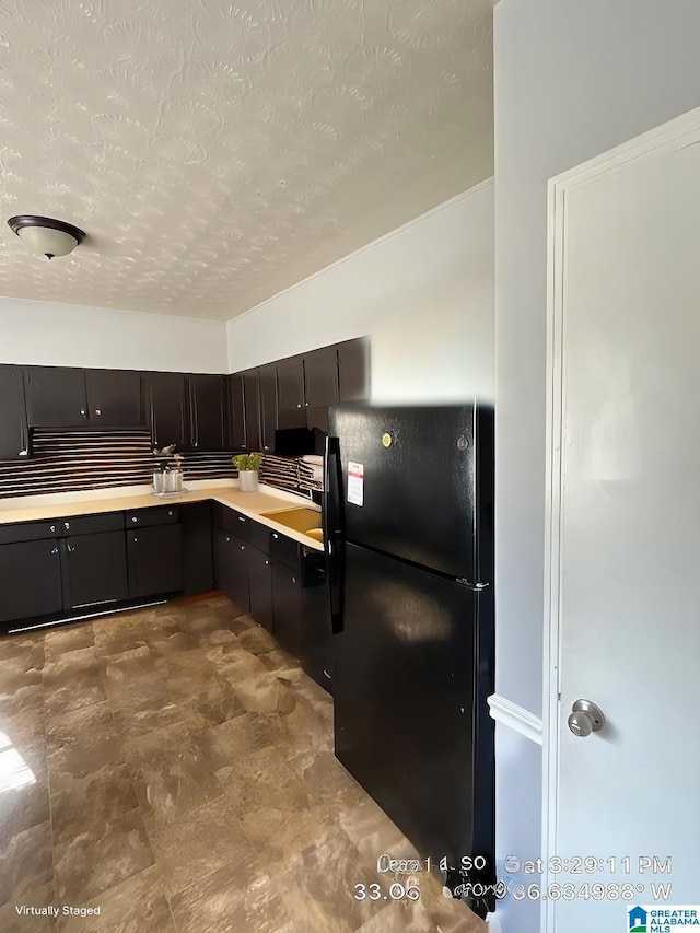 2610 Gaylon St, Birmingham, AL 35235 - kitchen featuring freestanding refrigerator, a textured ceiling, light countertops, and dishwasher