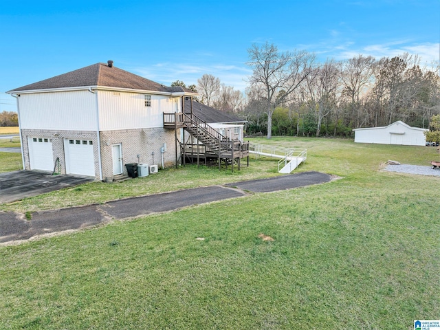 view of property exterior with driveway, stairway, an attached garage, brick siding, and a yard