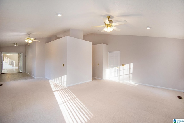 unfurnished room with lofted ceiling, ceiling fan, and light carpet