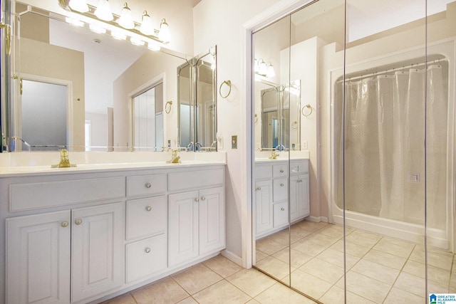 full bathroom featuring vanity, tile patterned floors, and a shower stall