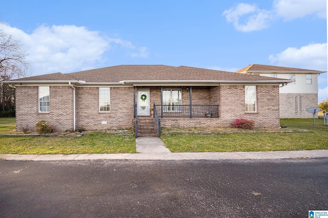 single story home with a front lawn, a porch, brick siding, and roof with shingles