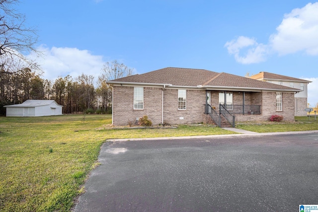 view of front of house with brick siding, roof with shingles, covered porch, and a front yard