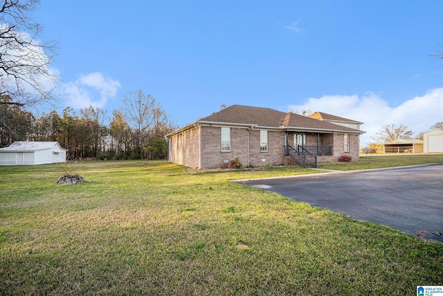 view of home's exterior with brick siding and a yard