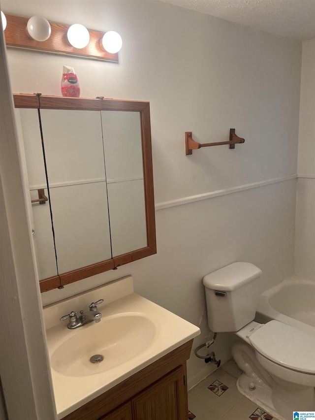 full bath with tile patterned floors, a bath, toilet, and vanity