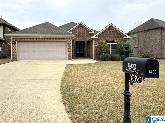 11433 Belle Meade Way, Northport, AL 35475 - view of front of home featuring roof with shingles, concrete driveway, brick siding, a front lawn, and a garage