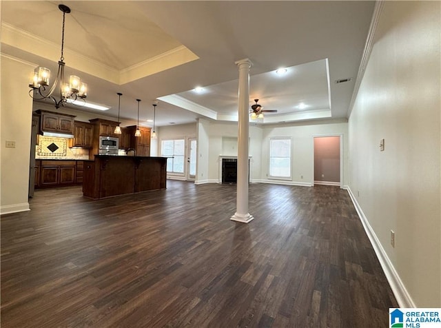 11433 Belle Meade Way, Northport, AL 35475 - unfurnished living room with visible vents, crown molding, a fireplace, dark wood-type flooring, and a tray ceiling