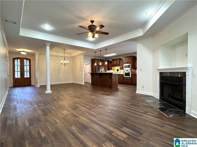 11433 Belle Meade Way, Northport, AL 35475 - unfurnished living room with ceiling fan with notable chandelier, a high end fireplace, dark wood-type flooring, and a raised ceiling