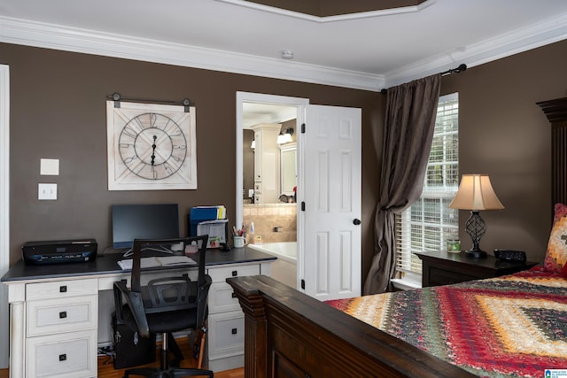bedroom with crown molding, decorative columns, and connected bathroom