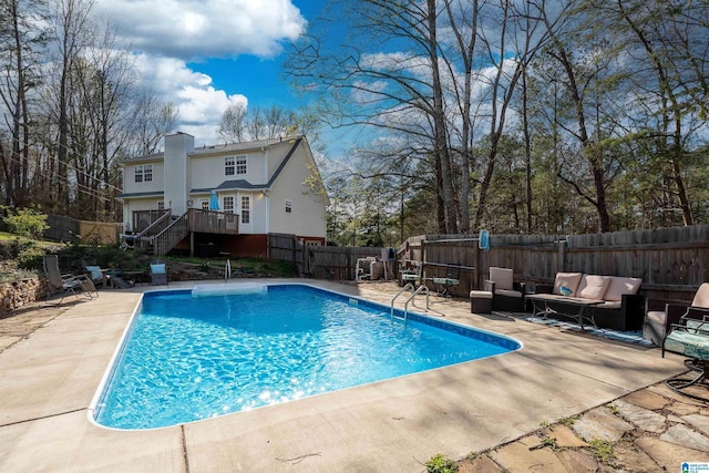 view of swimming pool featuring a fenced backyard, a fenced in pool, a patio area, and stairway