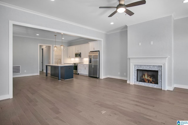 516 Preserve Pkwy, Hoover, AL 35226 - unfurnished living room with dark wood-style flooring, visible vents, crown molding, baseboards, and a ceiling fan