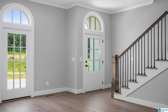 516 Preserve Pkwy, Hoover, AL 35226 - foyer entrance with visible vents, a healthy amount of sunlight, crown molding, and wood finished floors