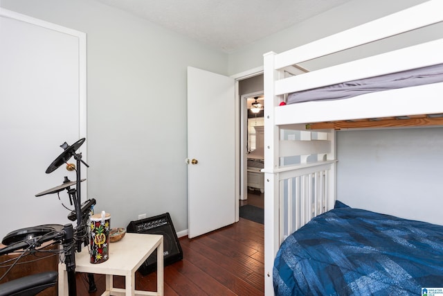 bedroom with wood-type flooring and a textured ceiling