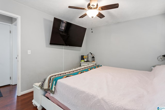 bedroom featuring baseboards, ceiling fan, and wood finished floors