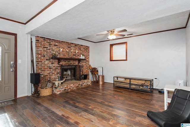 living area featuring a textured ceiling, ceiling fan, ornamental molding, and hardwood / wood-style flooring