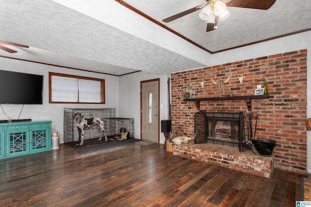 unfurnished living room with hardwood / wood-style floors, ceiling fan, ornamental molding, and a brick fireplace