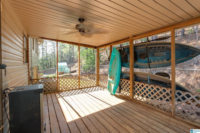 wooden terrace with a jacuzzi and ceiling fan