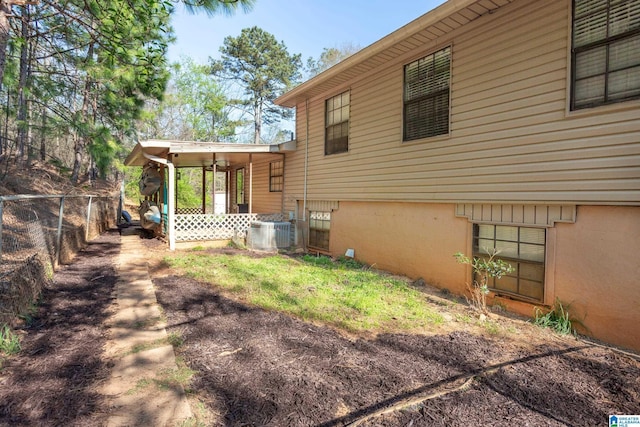 view of yard with fence and central AC unit