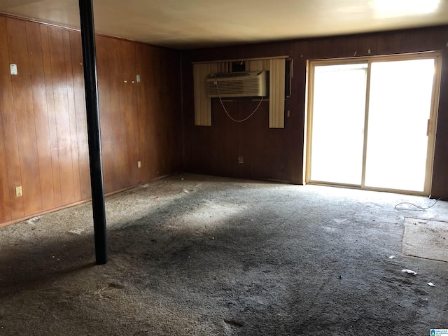 925 Ann St, Birmingham, AL 35228 - unfurnished living room with carpet floors, wood walls, and a wall mounted AC