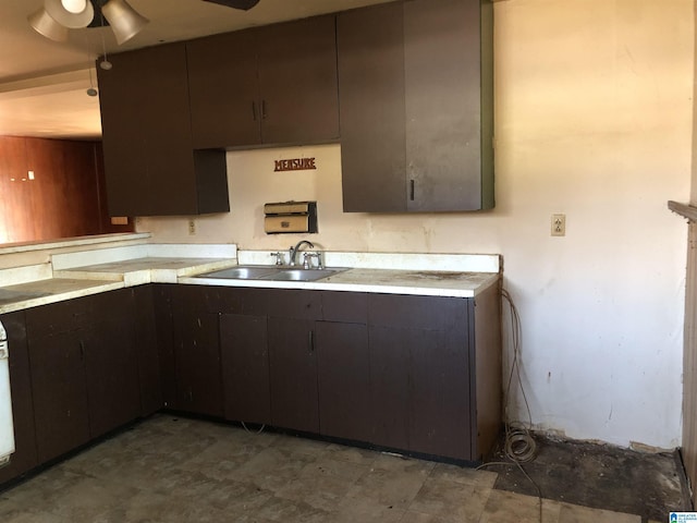 925 Ann St, Birmingham, AL 35228 - kitchen with light countertops, a sink, dark brown cabinets, and a ceiling fan