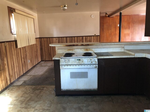 925 Ann St, Birmingham, AL 35228 - kitchen with light countertops, white range with electric stovetop, wood walls, and wainscoting
