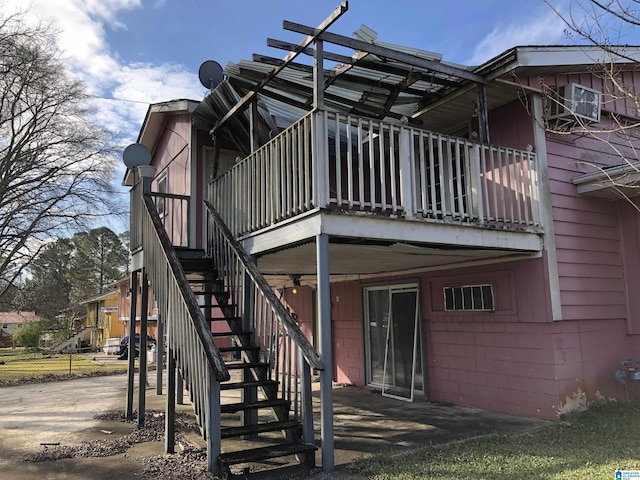 925 Ann St, Birmingham, AL 35228 - rear view of property featuring fence, concrete block siding, a patio, and stairway