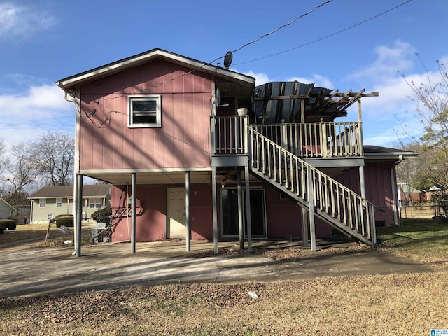 925 Ann St, Birmingham, AL 35228 - back of house with stairs, a deck, and a carport