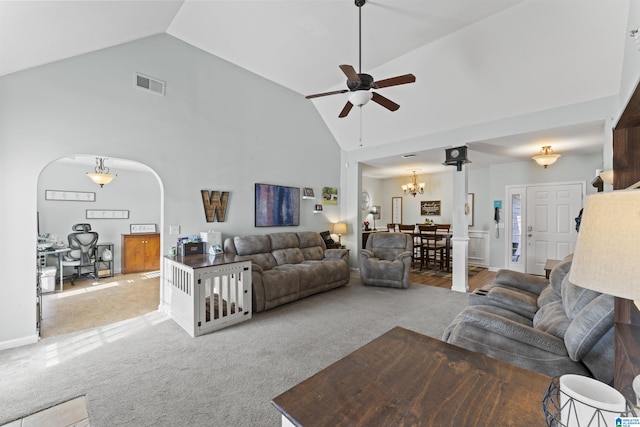 living room with carpet flooring, high vaulted ceiling, visible vents, arched walkways, and ceiling fan with notable chandelier