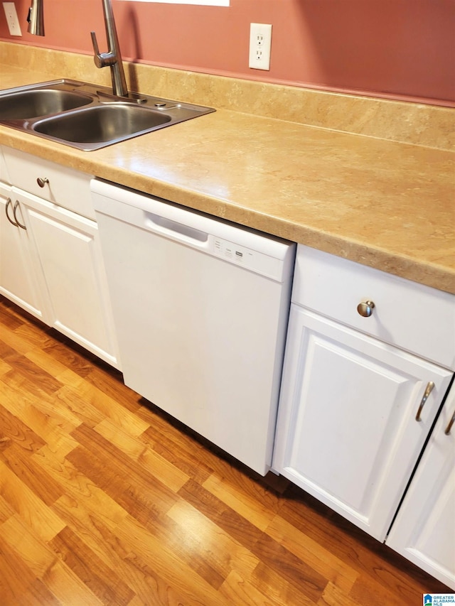 600 Mayfair Ln, Cullman, AL 35057 - kitchen featuring a sink, light wood-type flooring, dishwasher, and white cabinetry
