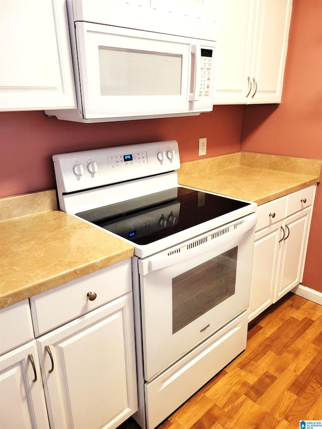 600 Mayfair Ln, Cullman, AL 35057 - kitchen featuring white appliances, white cabinetry, light countertops, and light wood-type flooring