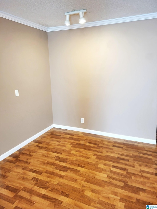 600 Mayfair Ln, Cullman, AL 35057 - spare room featuring a textured ceiling, baseboards, ornamental molding, and light wood-style flooring