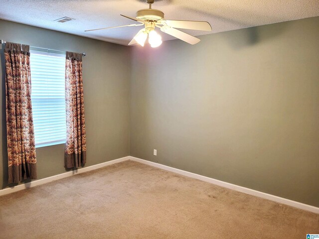 600 Mayfair Ln, Cullman, AL 35057 - empty room with light carpet, a textured ceiling, ceiling fan, and visible vents