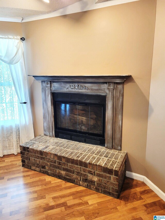 600 Mayfair Ln, Cullman, AL 35057 - interior details featuring baseboards, a fireplace, crown molding, and wood finished floors